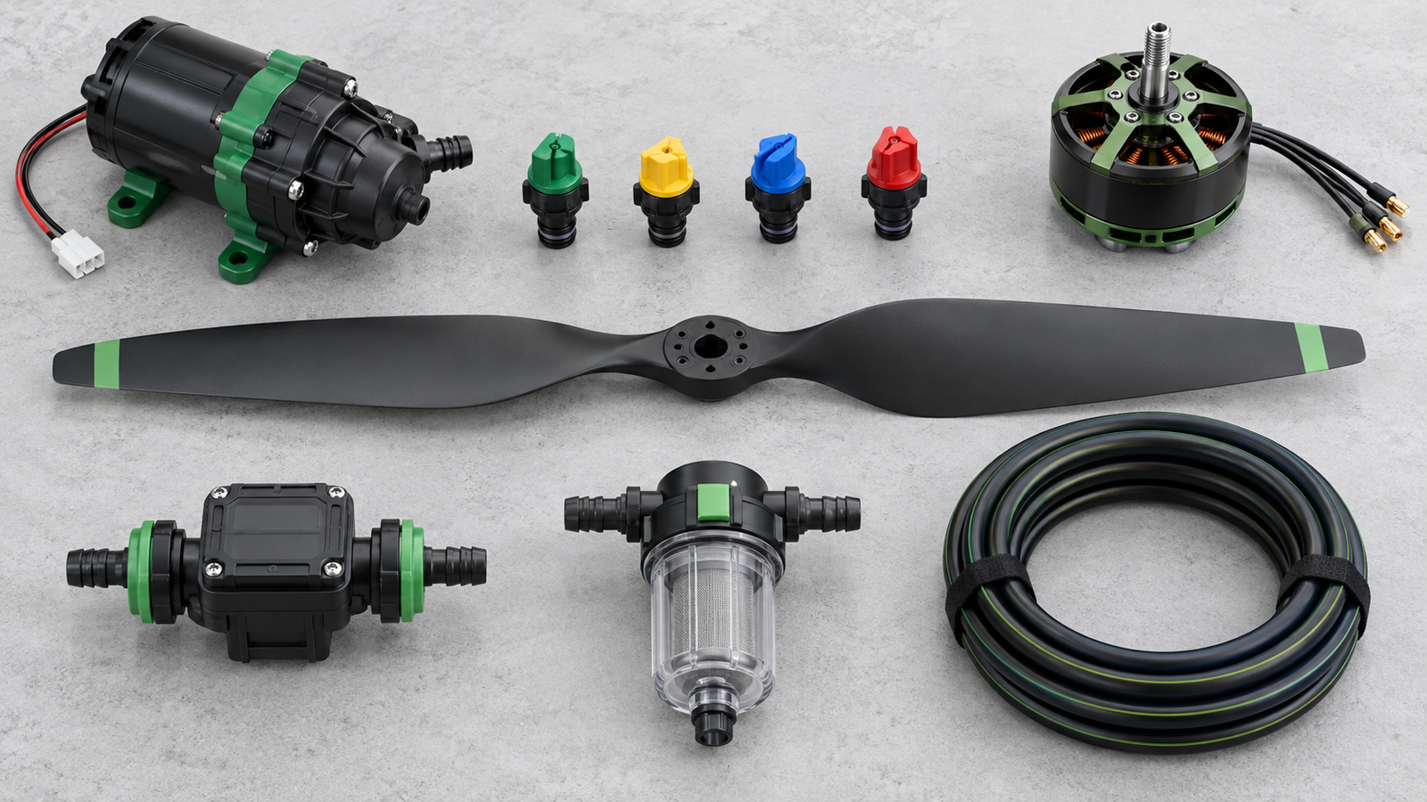 Spray pump, nozzle tips, motor, propeller and tubing components arranged on a workbench